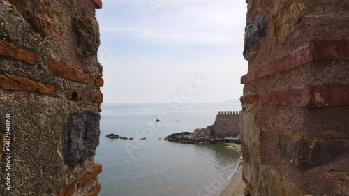 Castle Walls and Towers Surrounded by Water on a Cloudy Day