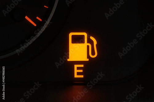 Fuel gauge warning light indicating low fuel level in vehicle  