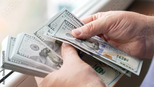 Принти на полотні Male hands handling a large amount of dollars