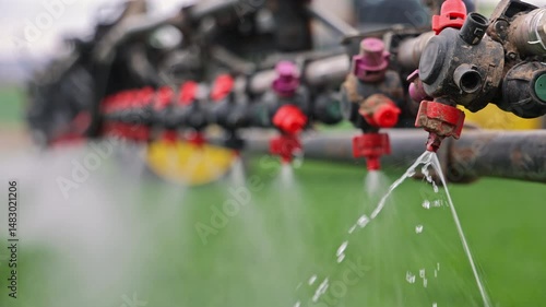 Close-up of sprayer nozzles releasing liquid onto crops, Precision agriculture equipment spraying fertilizer in fine jets