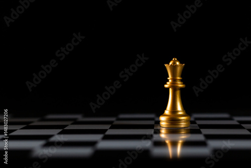 chess queen strategy leadership decision. golden chess queen stands out in the center board on a pitch black background, symbolizing leadership and strategy. golden chess queen is ideal for business.