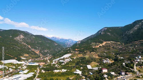 Aerial Slow Motion Drone Flight Over Green Mountains with Snow-Capped Peak. Stunning Landscape