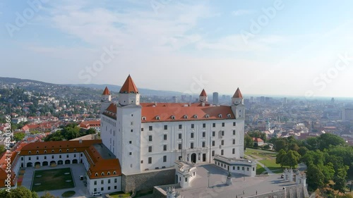 Aerial sunny summer morning view of Bratislava Castle or Bratislavsky hrad, the landmark on hill above the Old Town and Danube river, overlooking and dominating the capital. Famous symbol of the city.