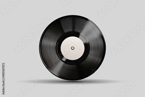 Black vinyl record, glossy finish, centered on a light gray background.  A circular, reflective surface with grooves and a white label