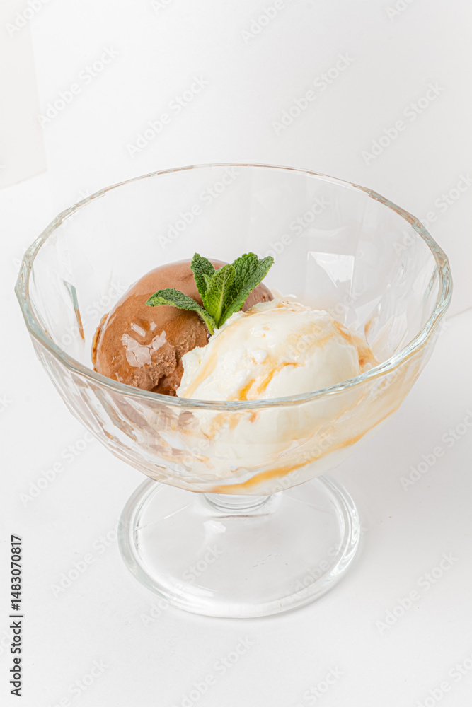 Indulgent two-scoop dessert features rich chocolate and creamy vanilla flavors, garnished with mint Indulgent two-scoop dessert features rich chocolate and creamy vanilla flavors, garnished with mint