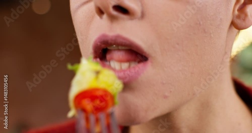 Close up shot of female chin and mouth chewing. Close up shot of woman in glasses. Close up view of female eating salad with fork. Woman tasting delicious meal. Face of attractive woman.