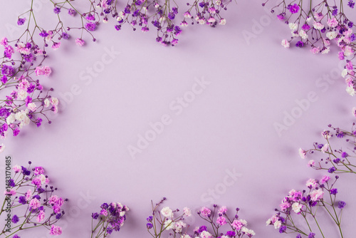 Creative layout of purple flowers composition on purple background. Flat lay with copy space.