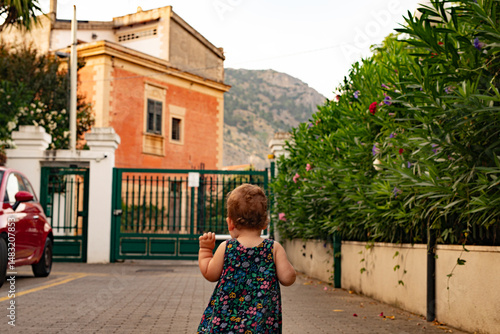 A cute toddler girl takes h...