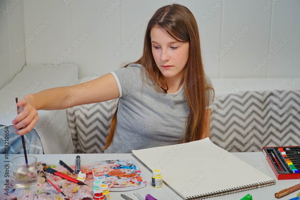 shot of a little girl painting with acrylics and imagining an idea at the table shot of a little girl painting with acrylics and imagining an idea at the table