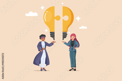 Combining Ideas for Innovation. Two Businesswomen Connecting Puzzle Pieces to Form a Bright Light Bulb.