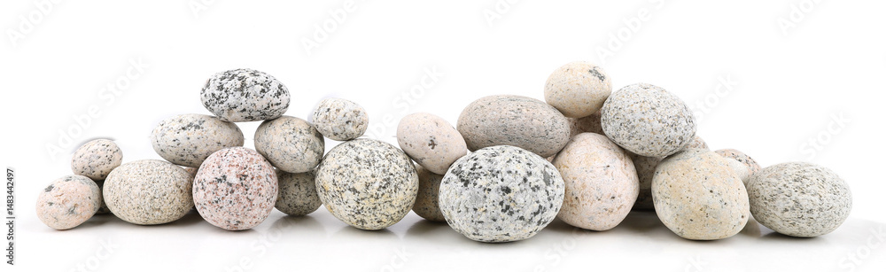 Sea washed oval pebbles isolated on white background. Arrangement of smooth round stones. Sea washed oval pebbles isolated on white background. Arrangement of smooth round stones.