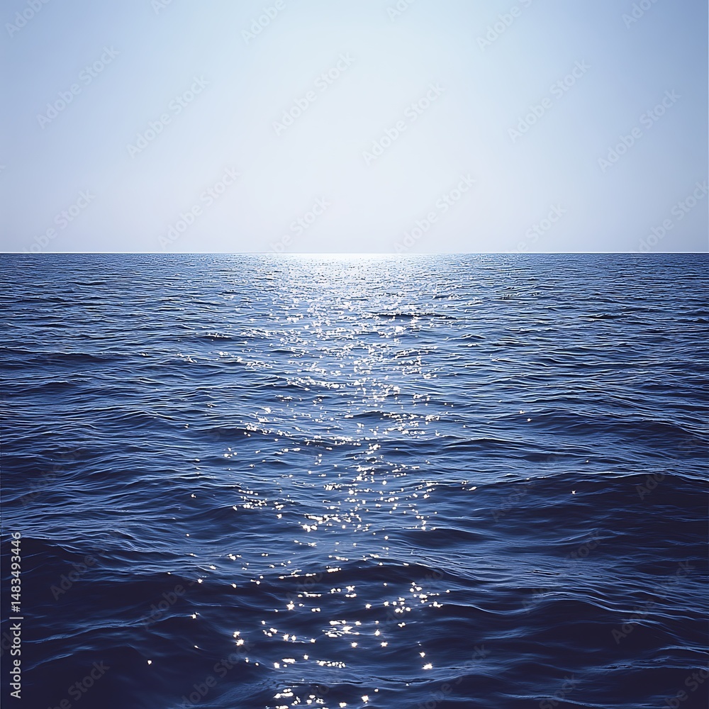 Fototapeta premium Calm blue ocean with gentle ripples reflecting sunlight, creating a peaceful and serene seascape under a clear, bright sky.