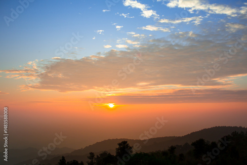 Wallpaper Mural Mountain view at sunrise or sunset, with orange sky in the background and shadows of trees in the foreground from low light in the morning or evening. Torontodigital.ca