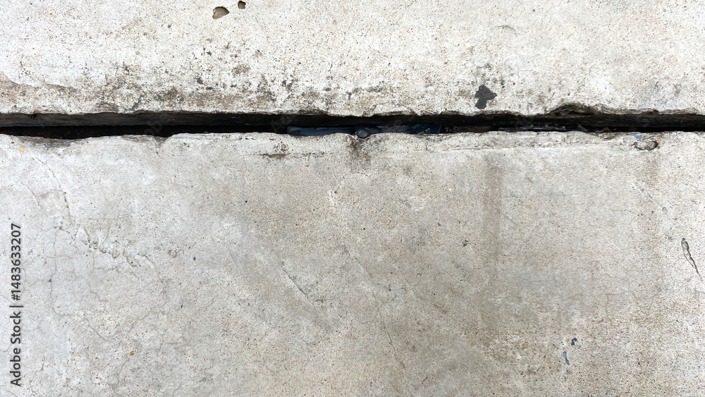 Obraz premium Cracked Concrete Surface with Visible Gap in Urban Setting