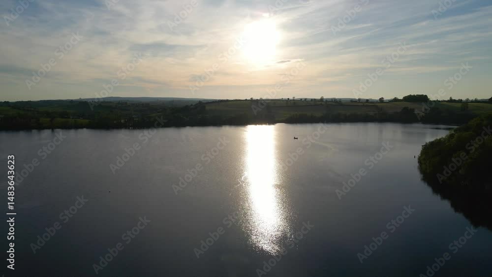 Lake scene with sunset reflecting on water. Emy Lough, Monaghan, Ireland Lake scene with sunset reflecting on water. Emy Lough, Monaghan, Ireland