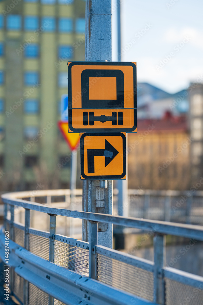 traffic sign for heavy vehicles and turn direction.