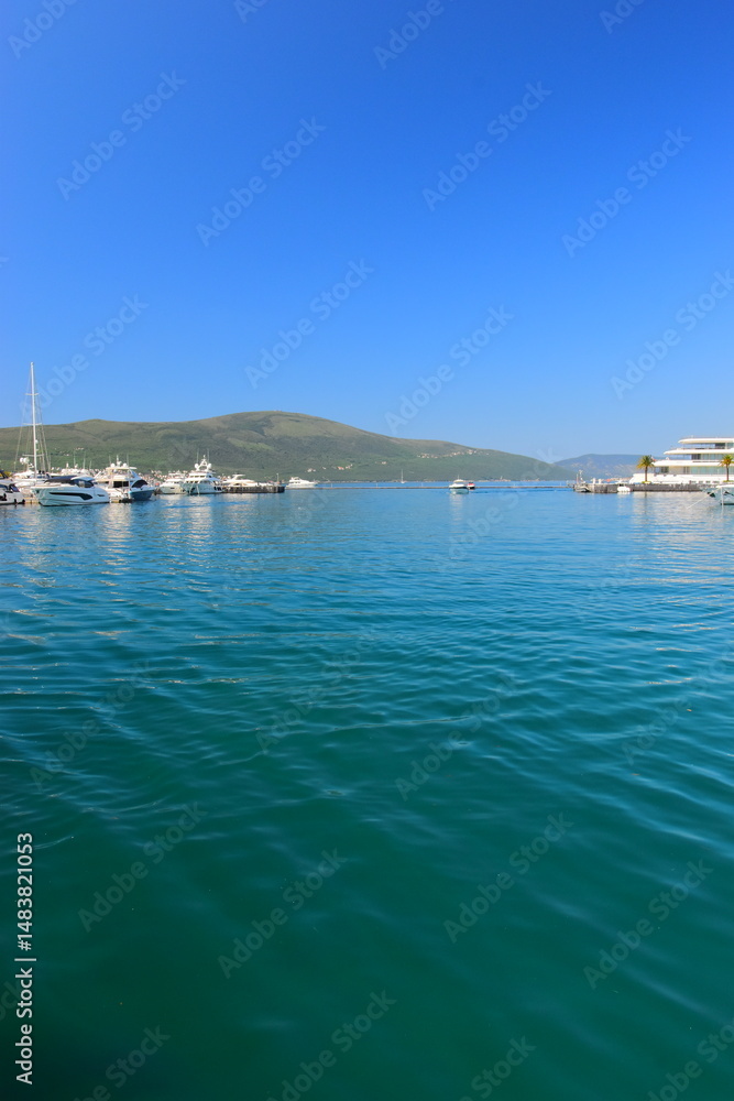 Obraz premium Tivat Montenegro 05052024 A walk through the luxury marina Porto Montenegro, luxury houses, luxury yachts, vacation at sea. On a hot, sunny, spring afternoon. 