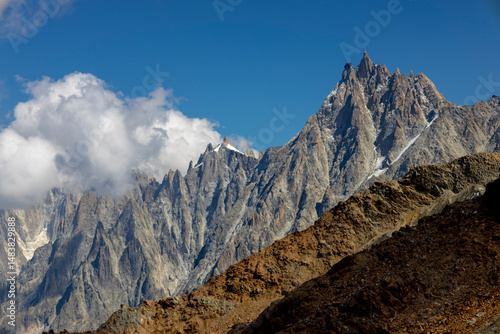 Aiguille du Midi peak above the clouds from the ascent to the summit of Montblanc view. Snow mountain ridge in the Alps, Chamonix Mont Blanc valley. Chamonix MontBlanc mountain landscape
