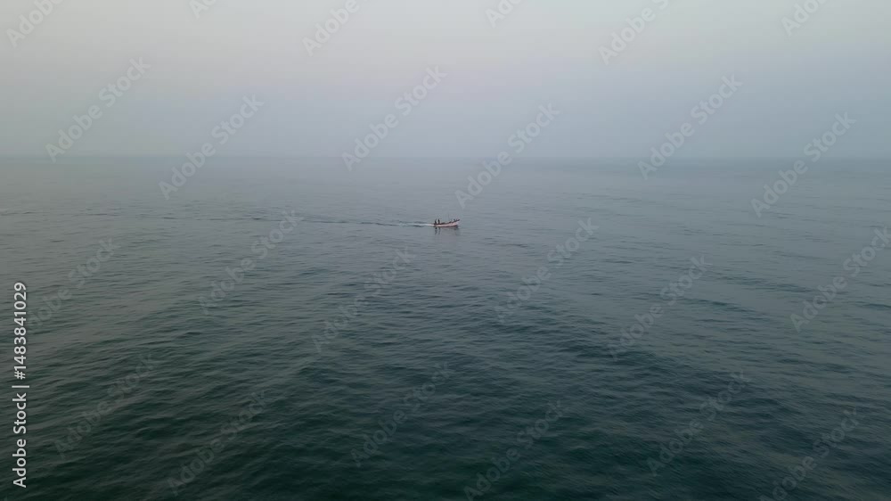 Distant view of a small fishing boat on the vast Indian Ocean Distant view of a small fishing boat on the vast Indian Ocean