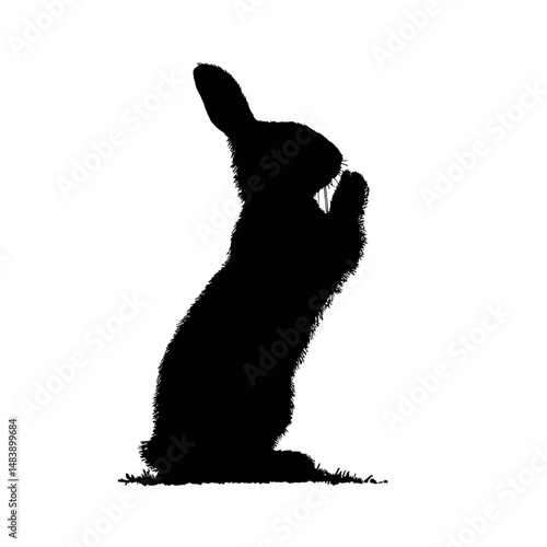 Solid black silhouette of a rabbit nibbling