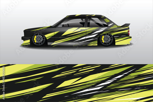 Sleek Black Car with Bold Yellow Stripes in Motion