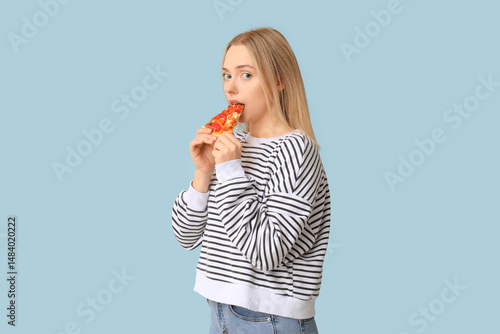 Young woman eating piece of...