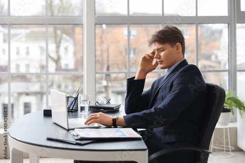 Tired young businessman suf...