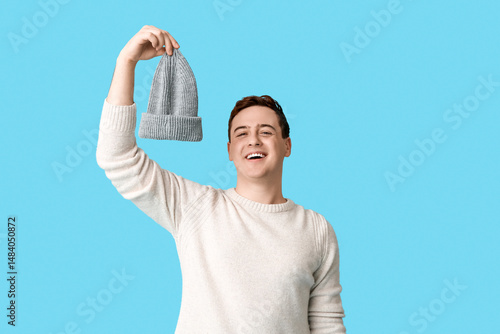 Young man with hat in his h...