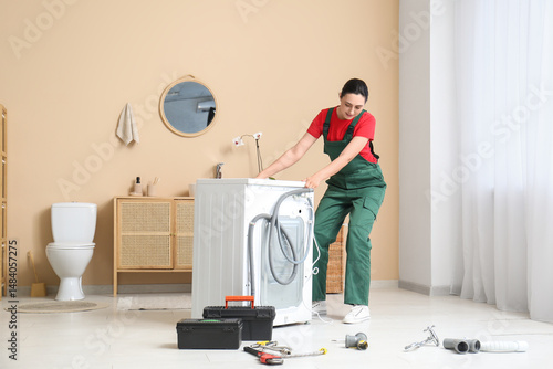 Female plumber moving washi...