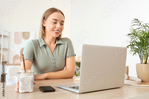 Young woman with laptop and...