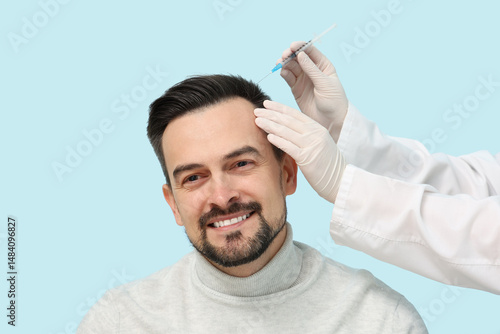 Young man receiving injecti...