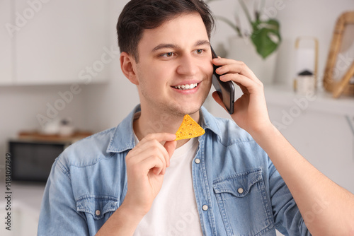 Young man talking by phone ...