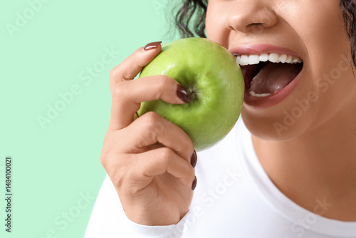 Young woman eating apple on...