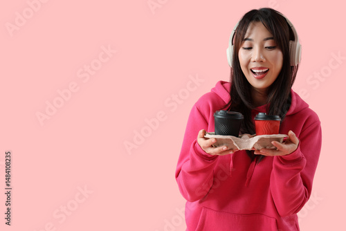 Young Asian woman with cups...