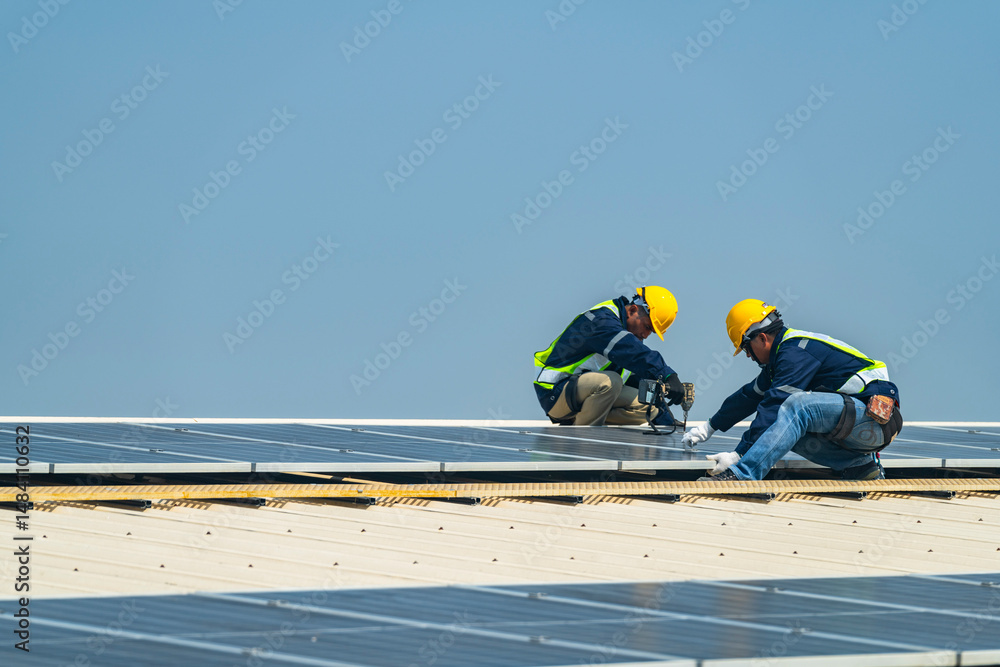 custom made wallpaper toronto digitalTwo engineers install solar panels on a rooftop, wearing safety gear and helmets. The scene showcases renewable energy, green technology, and sustainable solutions under a clear blue sky.