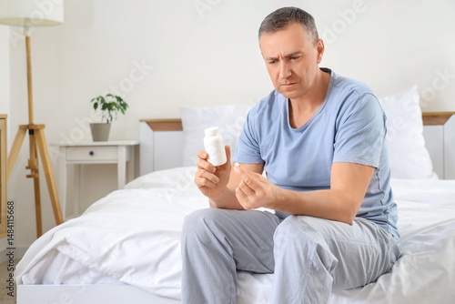 Mature man with pill bottle...