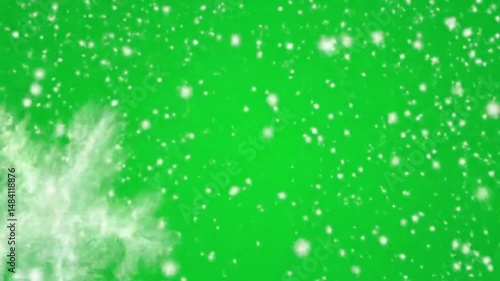 Snowflakes falling gently against a vibrant green screen background effect