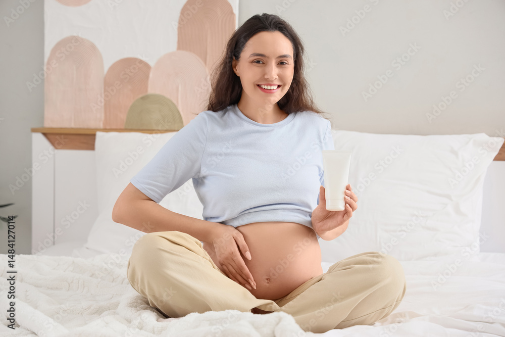 Young pregnant woman with body lotion at home Young pregnant woman with body lotion at home