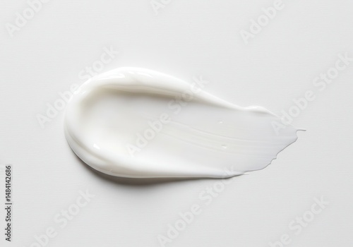 White cream swatch on a plain background, beauty product sample