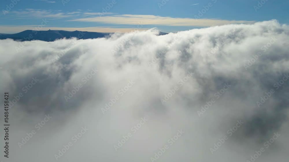 drone landing above the clouds mountains are visible in the distance drone landing above the clouds mountains are visible in the distance