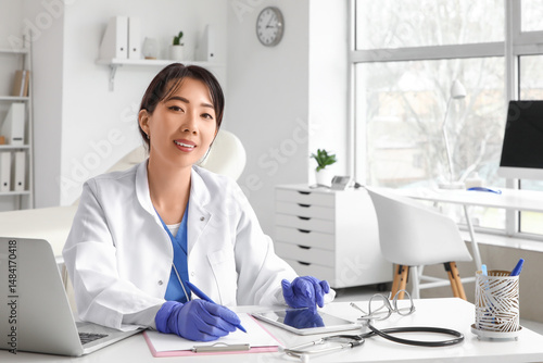Female Asian doctor working...