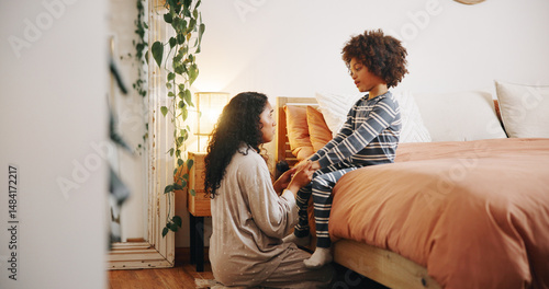 Photos Mom, child and talking in bedroom with holding hands, discipline and ready for bedtime at night