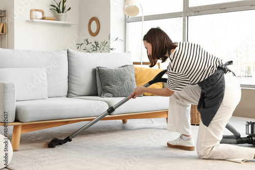 Female janitor vacuum clean...