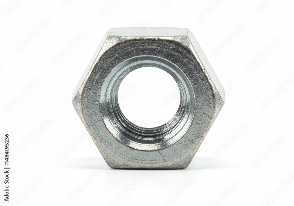 Close-up of a single silver hex nut on white background, showcasing its structure Close-up of a single silver hex nut on white background, showcasing its structure