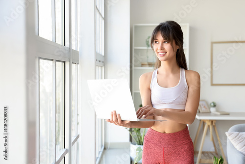 Sporty young woman using la...