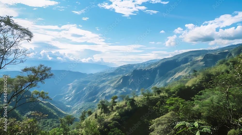 Naklejka premium Scenic Mountain Landscape Under A Bright Blue Sky And White Clouds