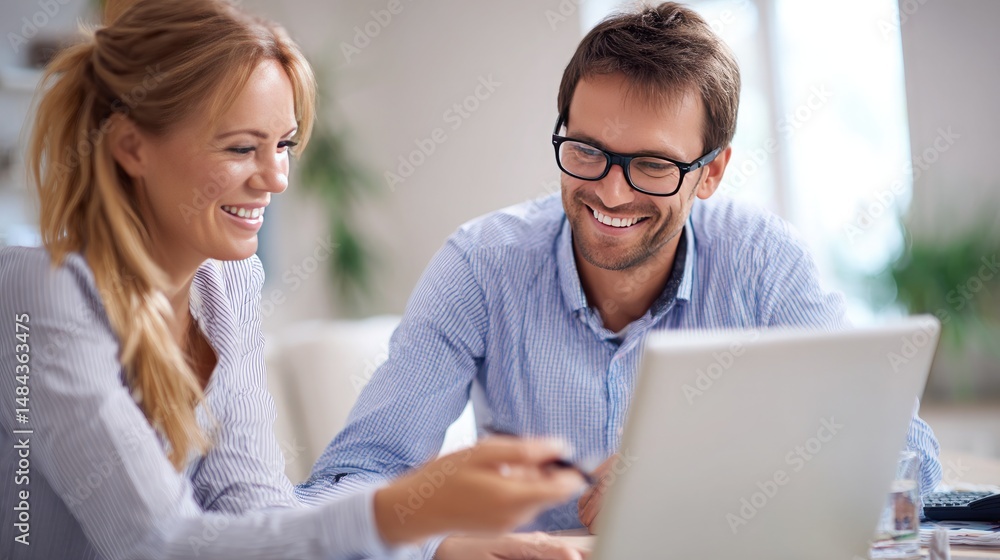 Obraz premium Happy young businessman in formalwear working with female colleague in office. Smiling businessman looking at camera, talking with colleague. Teamwork concept