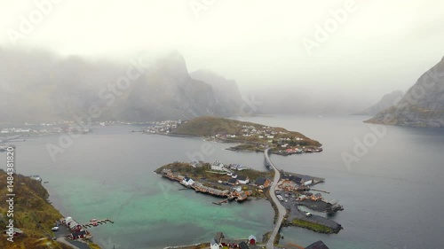 Breathtaking aerial view of majestic mountains enveloped in morning mist at Lofoten Islands, Norway, capturing serene natural beauty and dramatic Nordic landscapes.