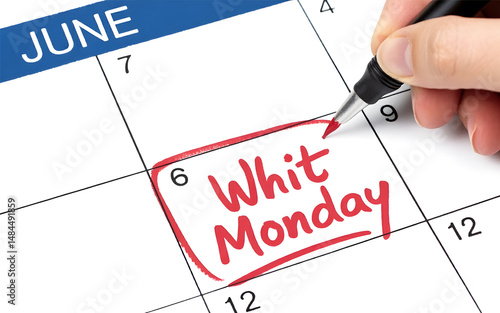 A calendar showing the date of whit monday in june with a hand circling the holiday in red