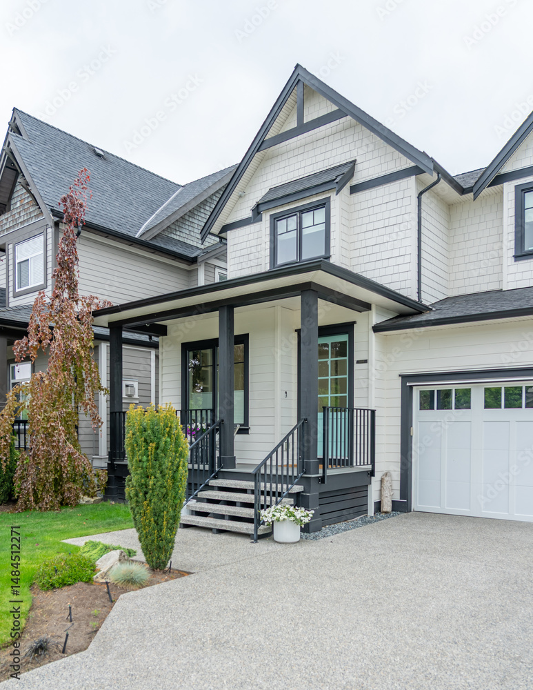 Fototapeta premium Entrance of grey painted luxury house in spring with stair steps and nice landscape in Vancouver, Canada, North America. Day time on April 2025.